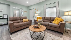 A living room with two brown leather sofas, a wooden coffee table, and a light-colored rug. - Closest to Springville Ranch & Gateway to the Sequoias•Pet Friendly•Sleeps 10 (Springville)