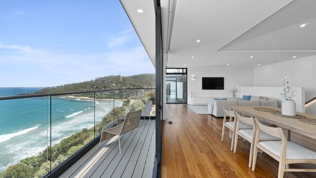 A modern interior with a balcony overlooking a coastal view. - Iluka Lookout | Unforgettable ocean views, new home (Wye River)