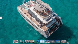 A large yacht with multiple decks, spacious outdoor seating areas, and a covered swimming area. - MUST SELL 1-3 wks ALL INCLUSIVE crewed BVI private yacht charter FP 67 Catamaran (Tortola)