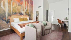 A bedroom with a bed, a desk, and a chair. - Cobo Escape | Heated Pool | MiniGolf | Game Room (Scottsdale)