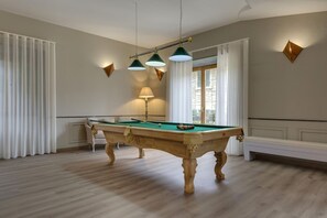 A pool table in a room with a bench, curtains, and wall sconces. - MyExclusiveItaly - Entire Hilltop Villa with Private Pool (Palazzuolo Sul Senio)