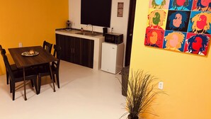 A compact kitchen with a dining area, a blackboard, and a vibrant pop art mural. - Vacation apartment with pool  (Willemstad)