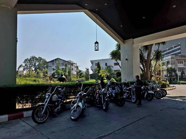 A covered parking area with multiple motorcycles parked. - First Pacific Cirrus - Pattaya (Pattaya)