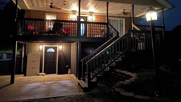 A two-story house with a covered porch, a staircase, and a garage. - Quiet & charming 3-bedroom, 3-story house located in Butler, Ohio. (Butler)