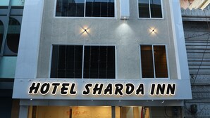 A multi-story building with a sign reading "HOTEL SHARDA INN." - Hotel Sharda Inn (Ujjain)