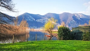 A grassy area with a lake and mountains in the background. - La Casetta sul Lago by Interhome (Iseo)