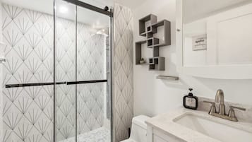 Shower, hair dryer, towels, shampoo
