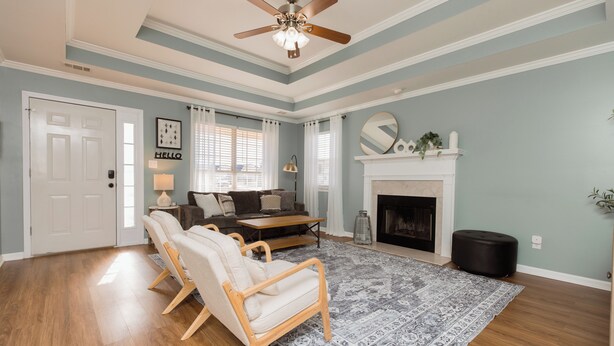 A living room with a fireplace, a ceiling fan, and a large rug. - Pet Friendly 3BR | Fenced Yard + Near RAFB (Warner Robins)