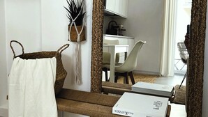 A modern living room with a sofa, a coffee table, and a bookshelf.