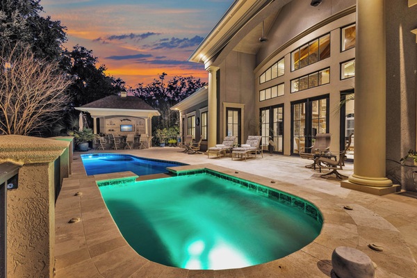 Outdoor Oasis: Private pool with built-in spa, bar with seating, grill, mini fridge, and outdoor shower for convenience.