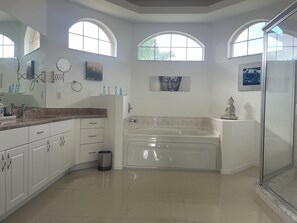Shower, jetted bath, hair dryer, towels - The ArtHouse - modern, stylishly furnished vacation home with pool! (Lehigh Acres)