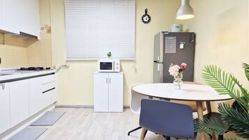 Fridge, electric kettle, cookware/dishes/utensils, dining tables