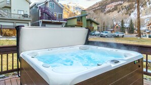 A hot tub on a deck with a mountainous backdrop. - Tomboy Lodge 144 1 Bedroom Condo (Telluride)