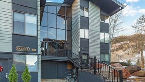 A modern two-story building with a prominent glass facade, a visible staircase, and a sign reading "GALENA." - Tomboy Lodge 144 1 Bedroom Condo (Telluride)