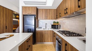 Enjoy cooking in this well-equipped kitchen with a gas stove, sink, and dishwasher.