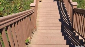 A wooden staircase leading to a beach with clear blue water. - Sunsets over Long Island Sound Peace and Tranquility 
Monthly Rentals Available  (Calverton)