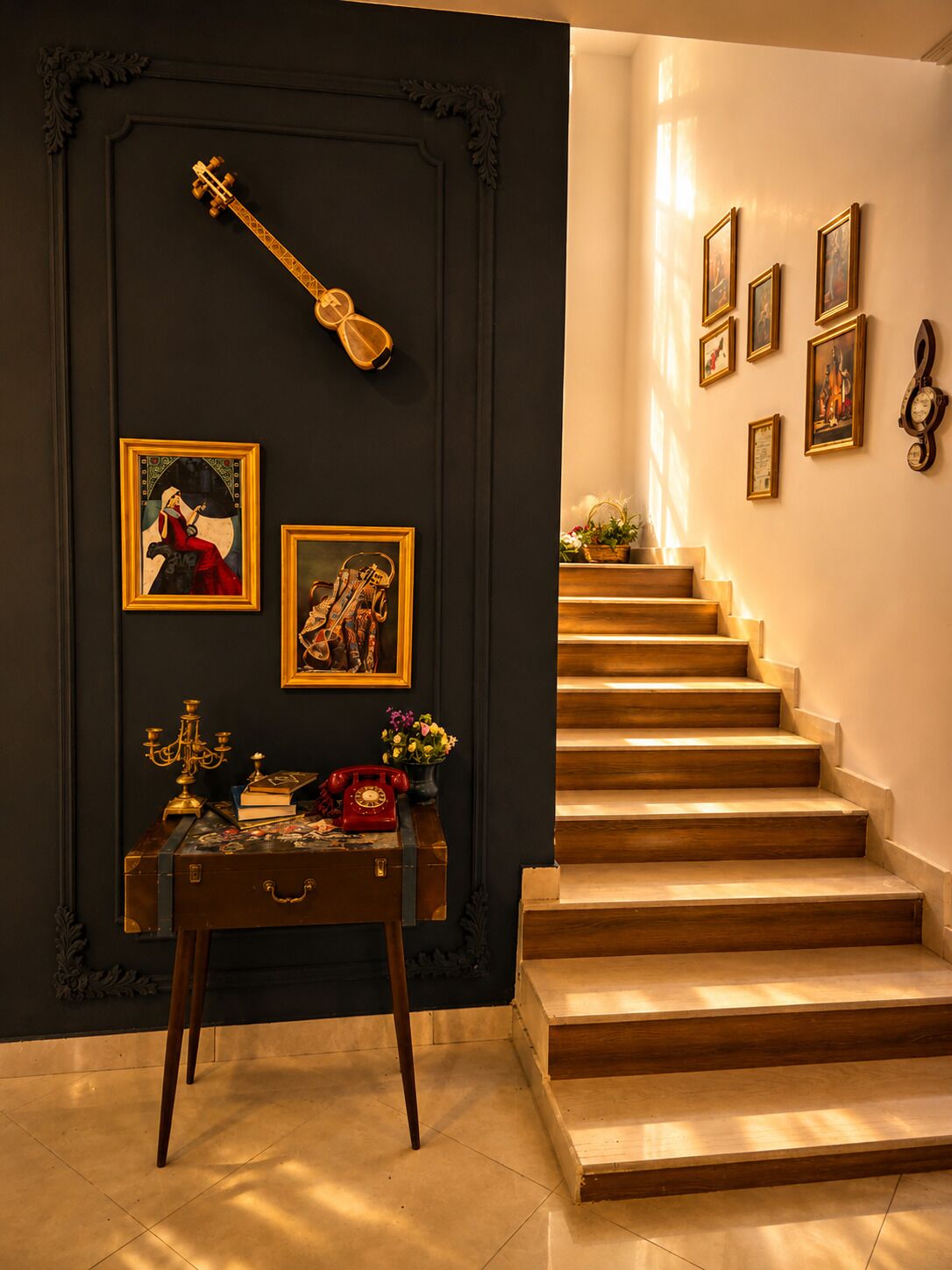 A staircase with wooden steps and a dark wall with framed artwork and a decorative item.