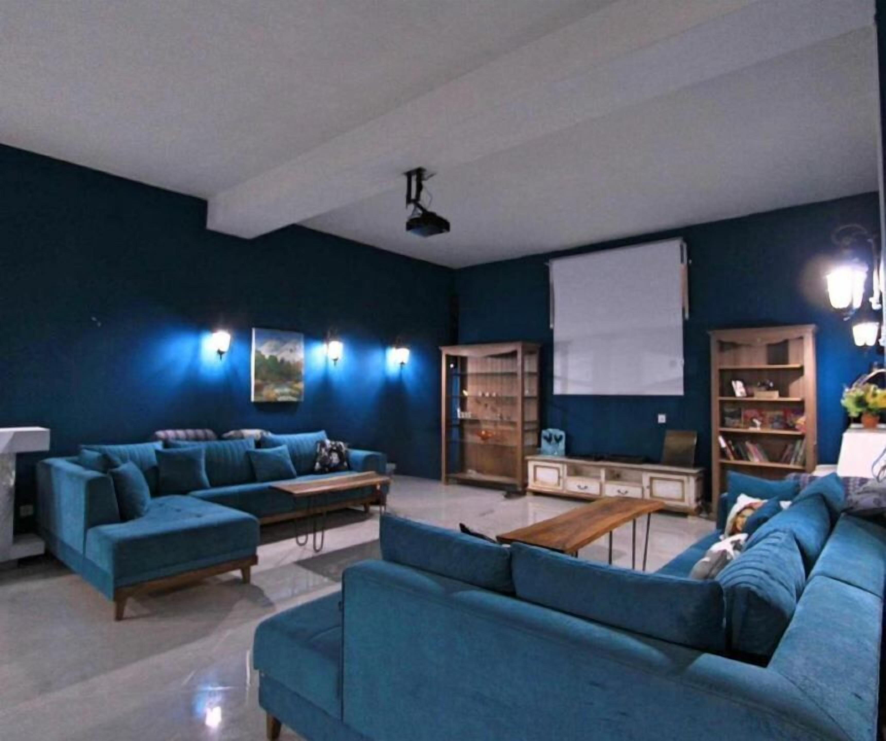 Una sala de estar con un sofá seccional, una mesa de centro y estanterías empotradas.