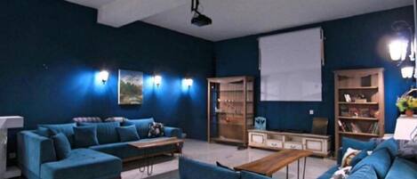 A living room with a sectional sofa, a coffee table, and built-in shelving.