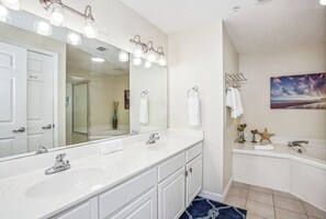 A modern bathroom with two sinks, a large mirror, and a bathtub. - Fiddler on The Reef, Navarre Beach FL (Navarre)