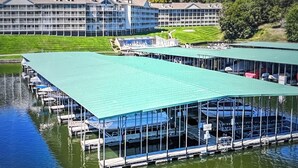 A large hotel with multiple buildings and a dock area with boats.
