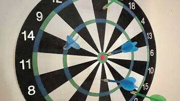 A dartboard with multiple darts stuck in it.