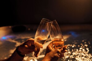 Two hands holding champagne glasses. - Portside Paradise updated cabin w hottub (Afton)