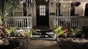 A house with a black front door, white picket fence, and a small porch area. - 3bedroom/2bath home with Private Pool! Downtown St Augustine, quiet and walkable (St. Augustine)