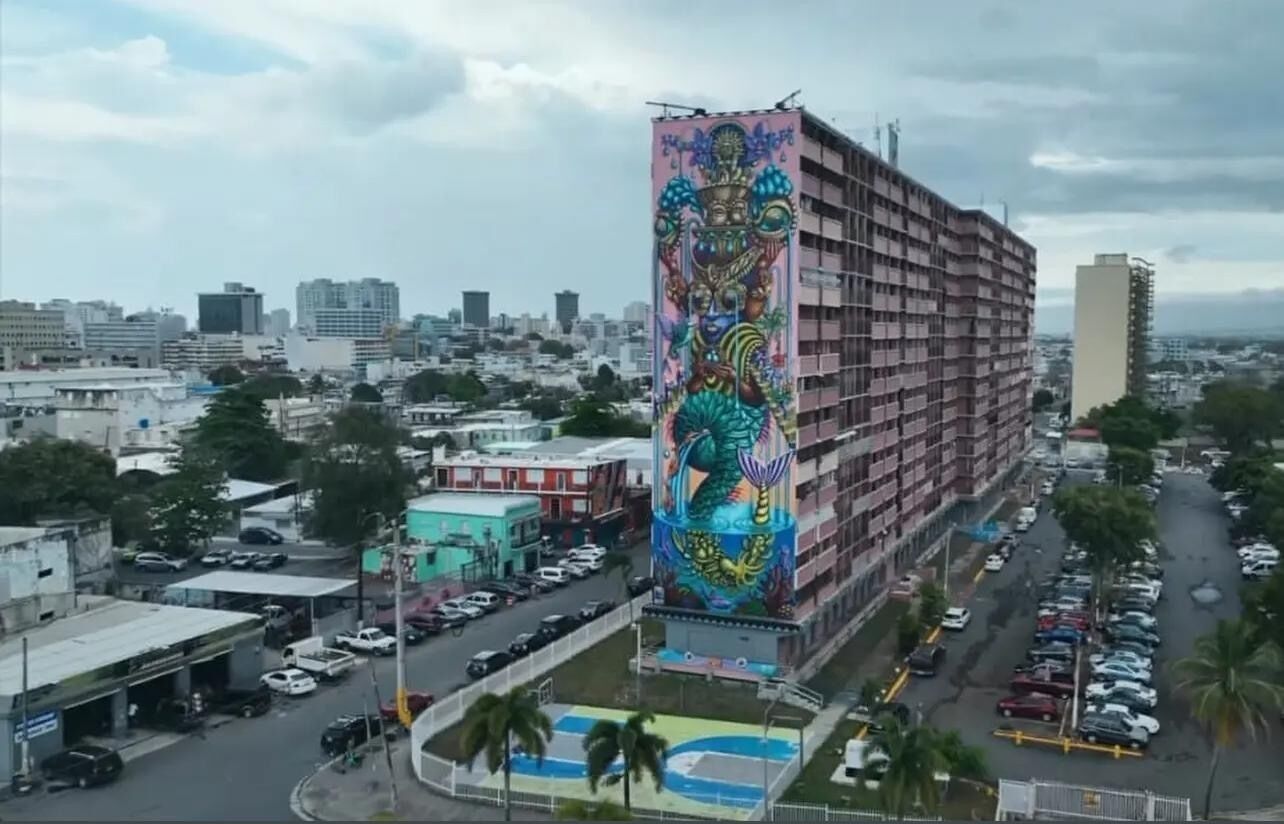 A tall building with a colorful mural on its facade.
