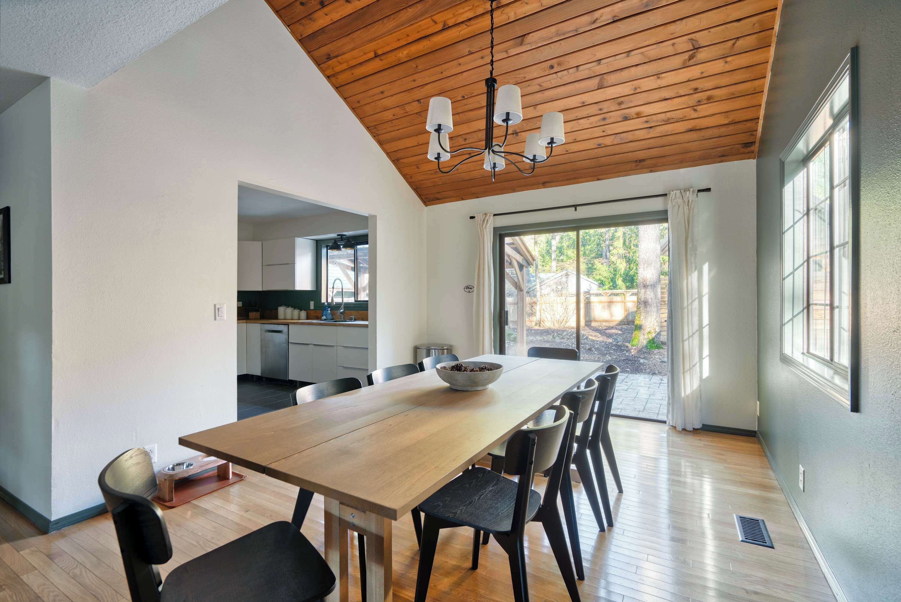 A modern kitchen with white cabinets and a wooden countertop.