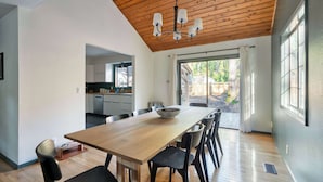 A modern kitchen with white cabinets and a wooden countertop.