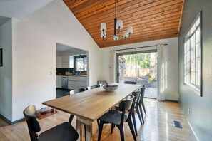 A modern kitchen with white cabinets and a wooden countertop.
