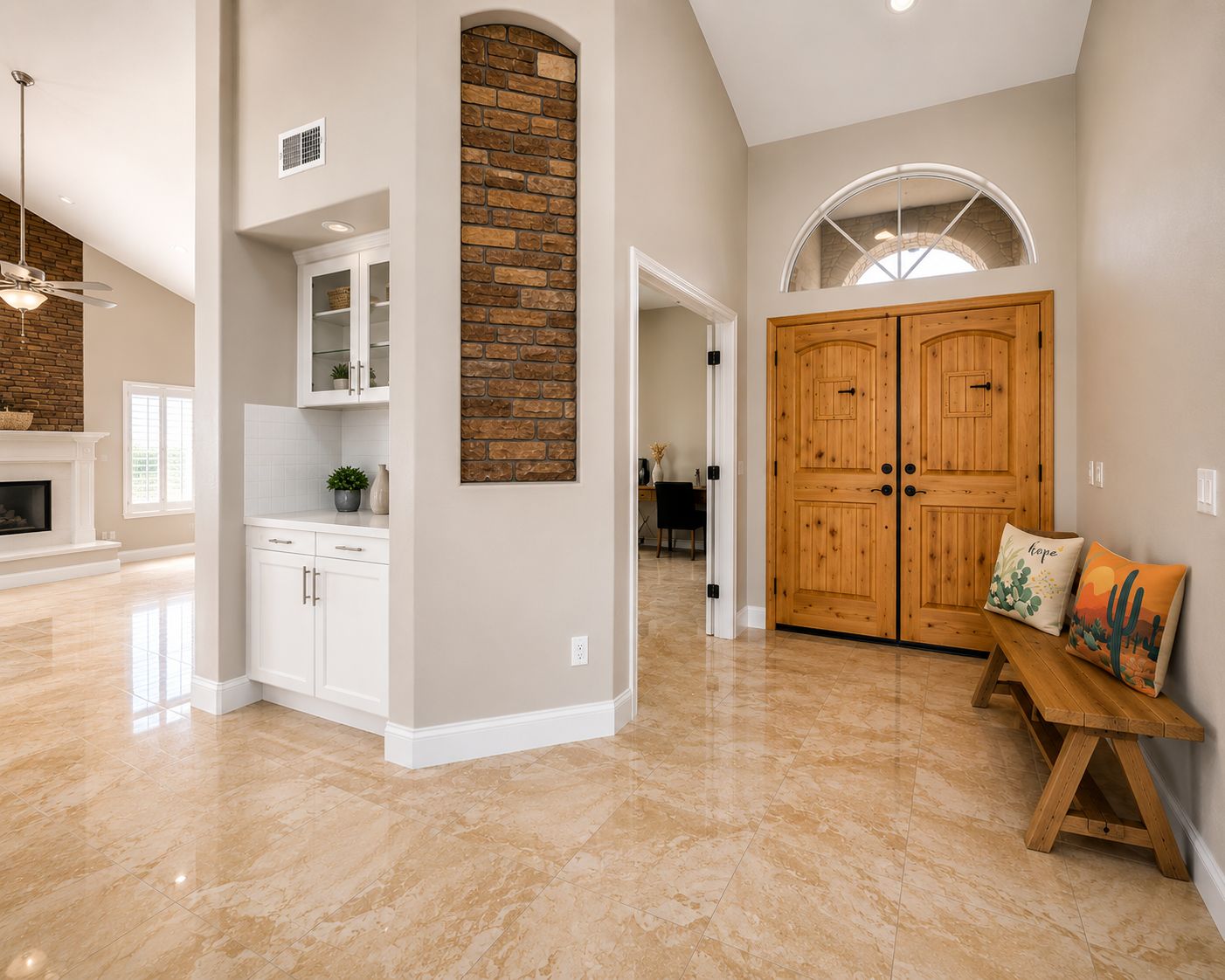 A spacious interior with a kitchen, dining area, and a large wooden door.
