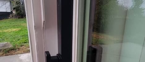 A glass door with a black handle and a latch.