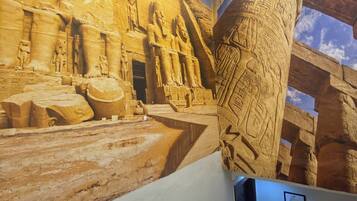 A wall mural of ancient Egyptian hieroglyphs and statues.