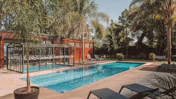 Indoor pool, outdoor pool, pool umbrellas, pool loungers