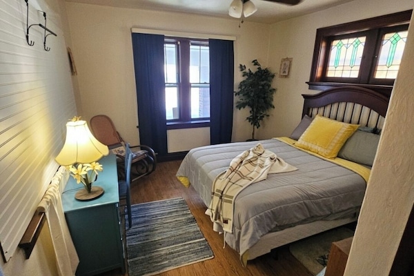 Large bedroom suite nxt to bth with desk, rocking chair and room for child space