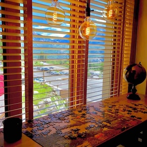 A window with blinds, a puzzle on the table, and a globe. - Mountain view Durango ski-in/out@ Purgatory Resort (Durango)