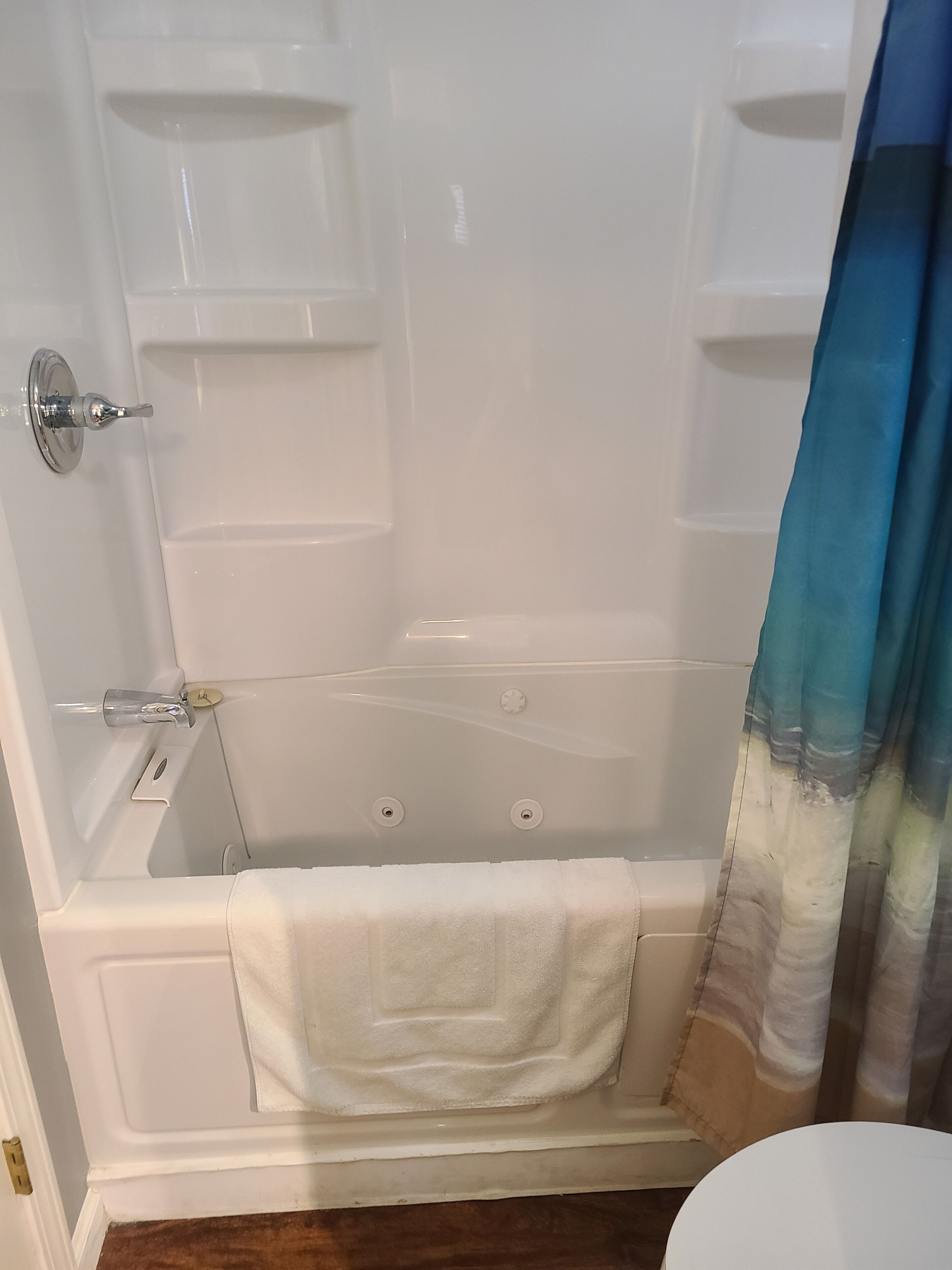A bathroom with a bathtub, a shower, a toilet, and a sink.