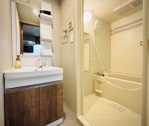 Separate bathtub and shower, rainfall showerhead, designer toiletries
