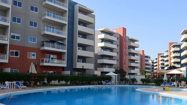 Pool - Al Reef Retreat: Your 1BR w/ Sofa Beds, Pool & Gym (Abu Dhabi)