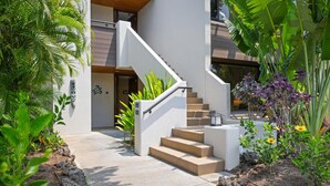 A modern building with a concrete staircase leading to a door marked "Entrance."