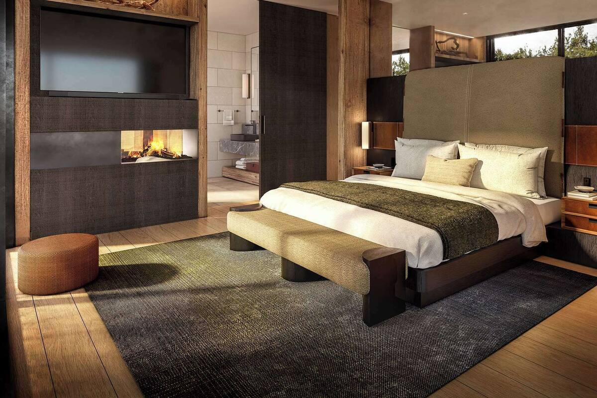 A modern bedroom with a large bed, a fireplace, and a view of the outdoors.