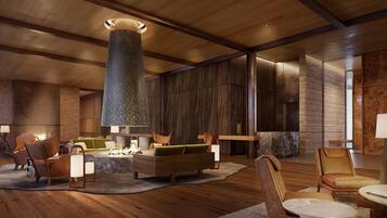A spacious lobby with a high ceiling, a central pillar, and a seating area with sofas and chairs.