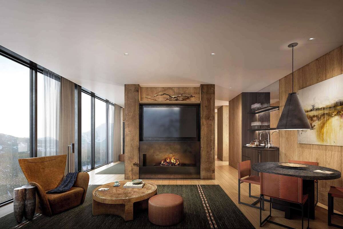 A modern living room with a fireplace, large windows, and a dining area.