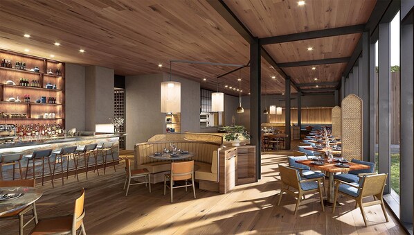 Enjoy a warm and inviting dining experience in our restaurant, featuring a bar area, comfortable seating, and large windows with outdoor views.