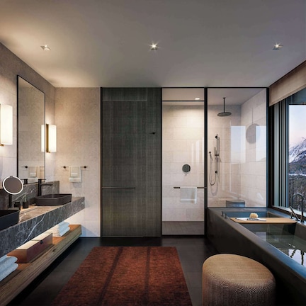 A modern bathroom with a large mirror, two sinks, a shower, and a bathtub.