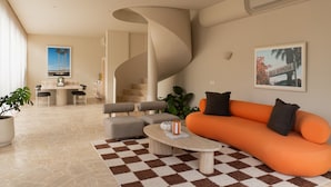 Un salon moderne doté d’un escalier à volutes, d’un coin repas et d’une grande fenêtre.