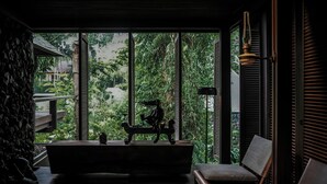 A room with a large window, a bench, and a statue. - Janjisurga by Ekosistem (Cepaka)