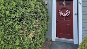 A house with a red door, a wreath, and a mailbox.